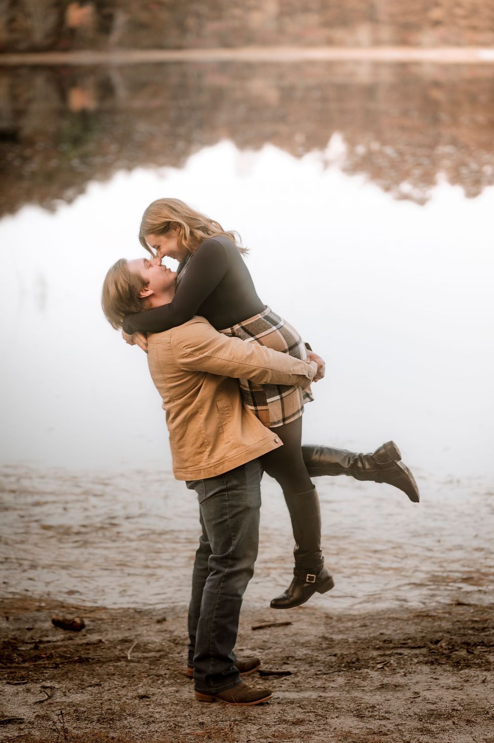 A romantic couple embraces and spins joyfully on muddy ground in a series of candid outdoor moments.