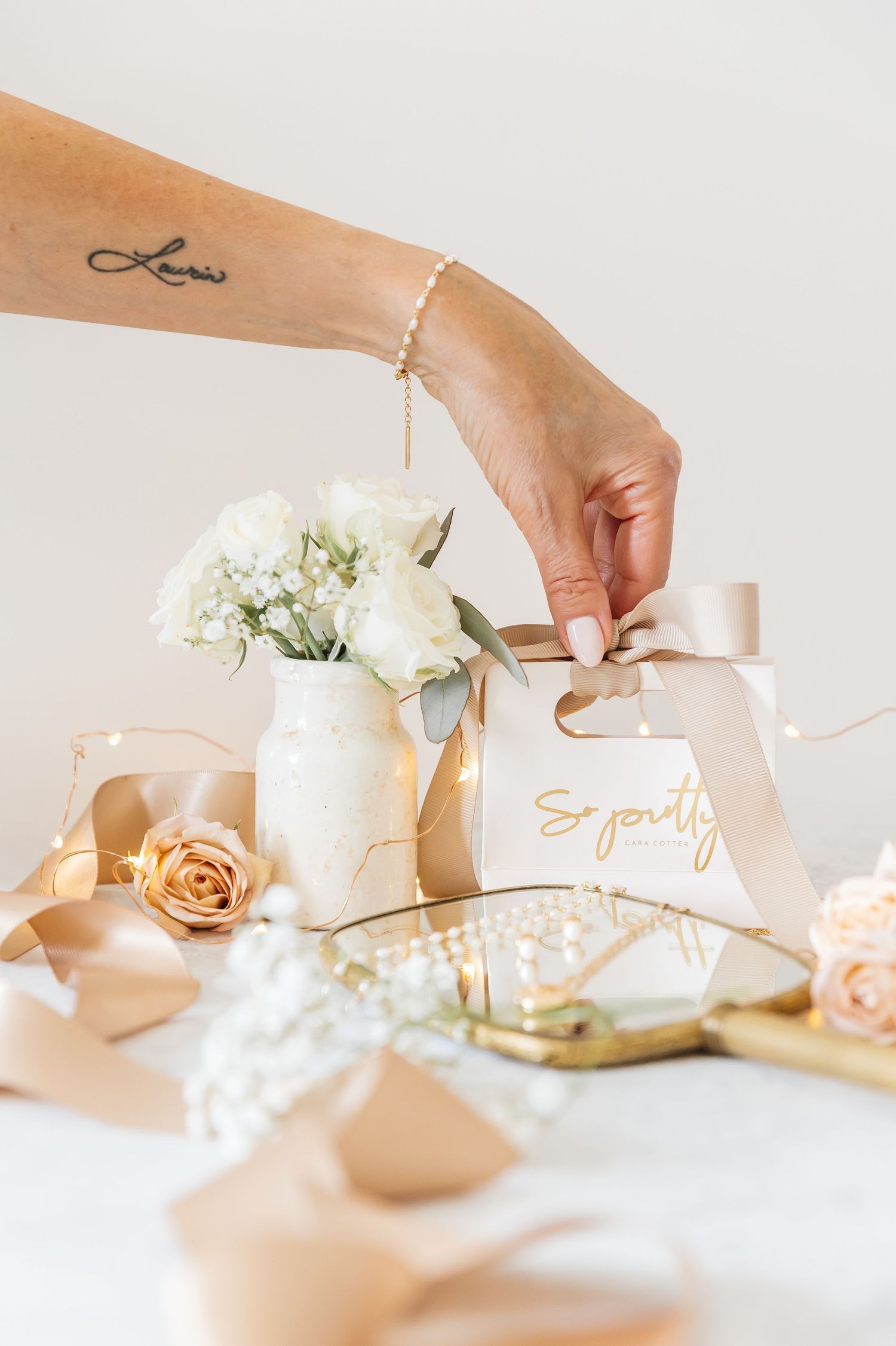 product photography of roses and jewelry on a white backdrop during a branding session in Kelowna, BC