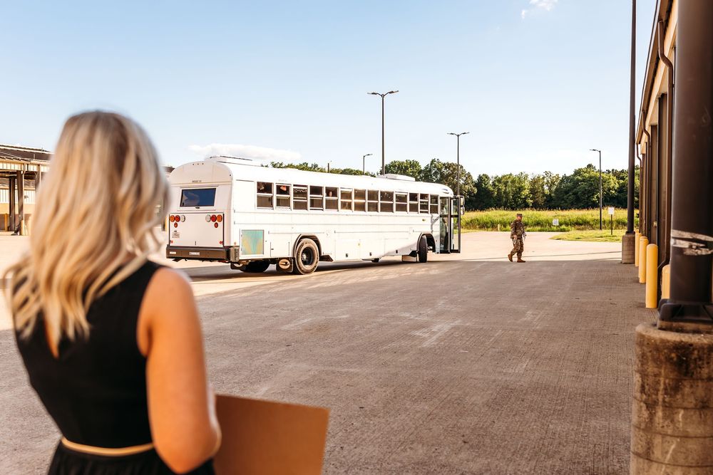 A wife watches her husband pull away during a military deployment from Connecticut in autumn