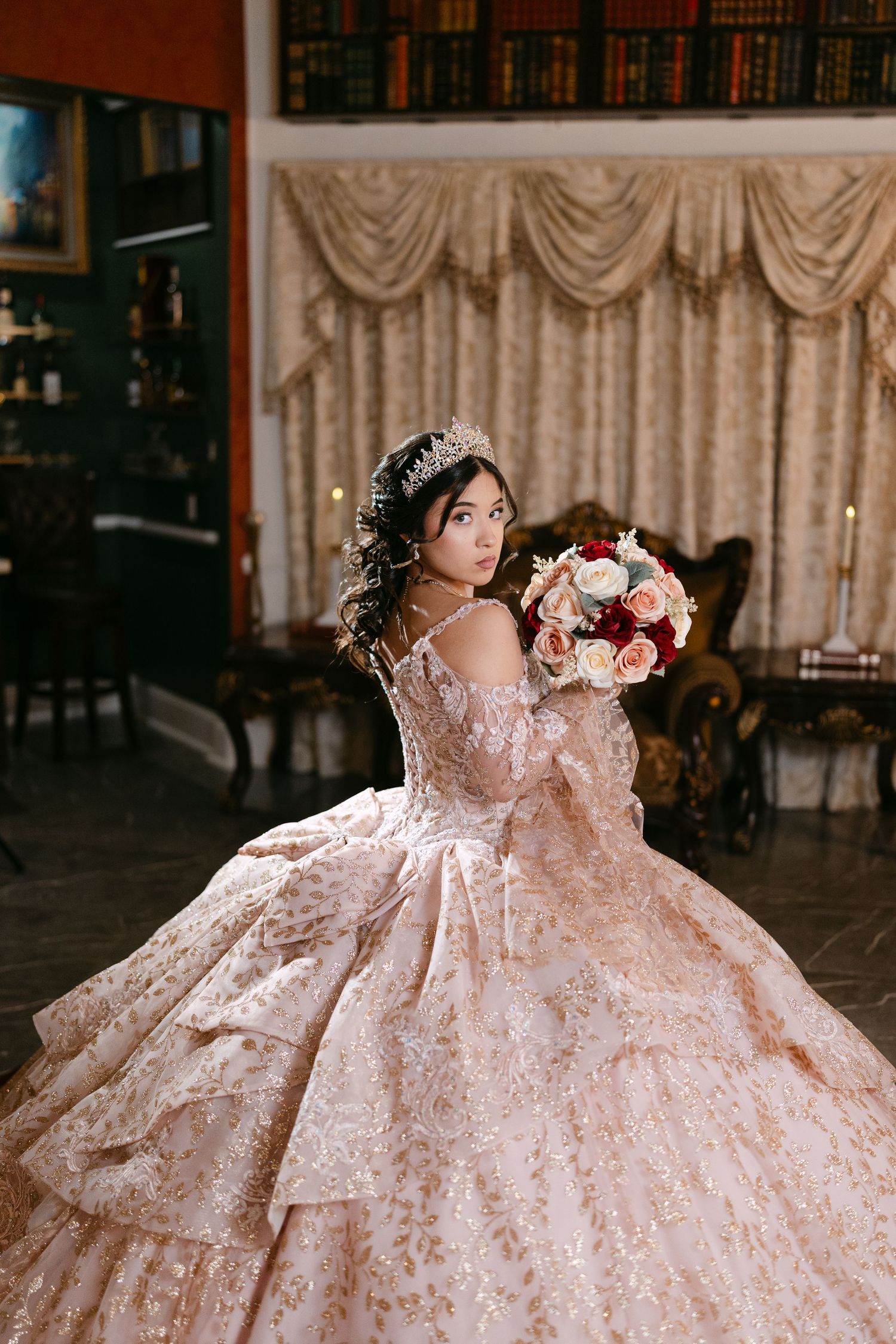 A quinceañera dress in blush pink with intricate lace details is showcased in a series of elegant poses.