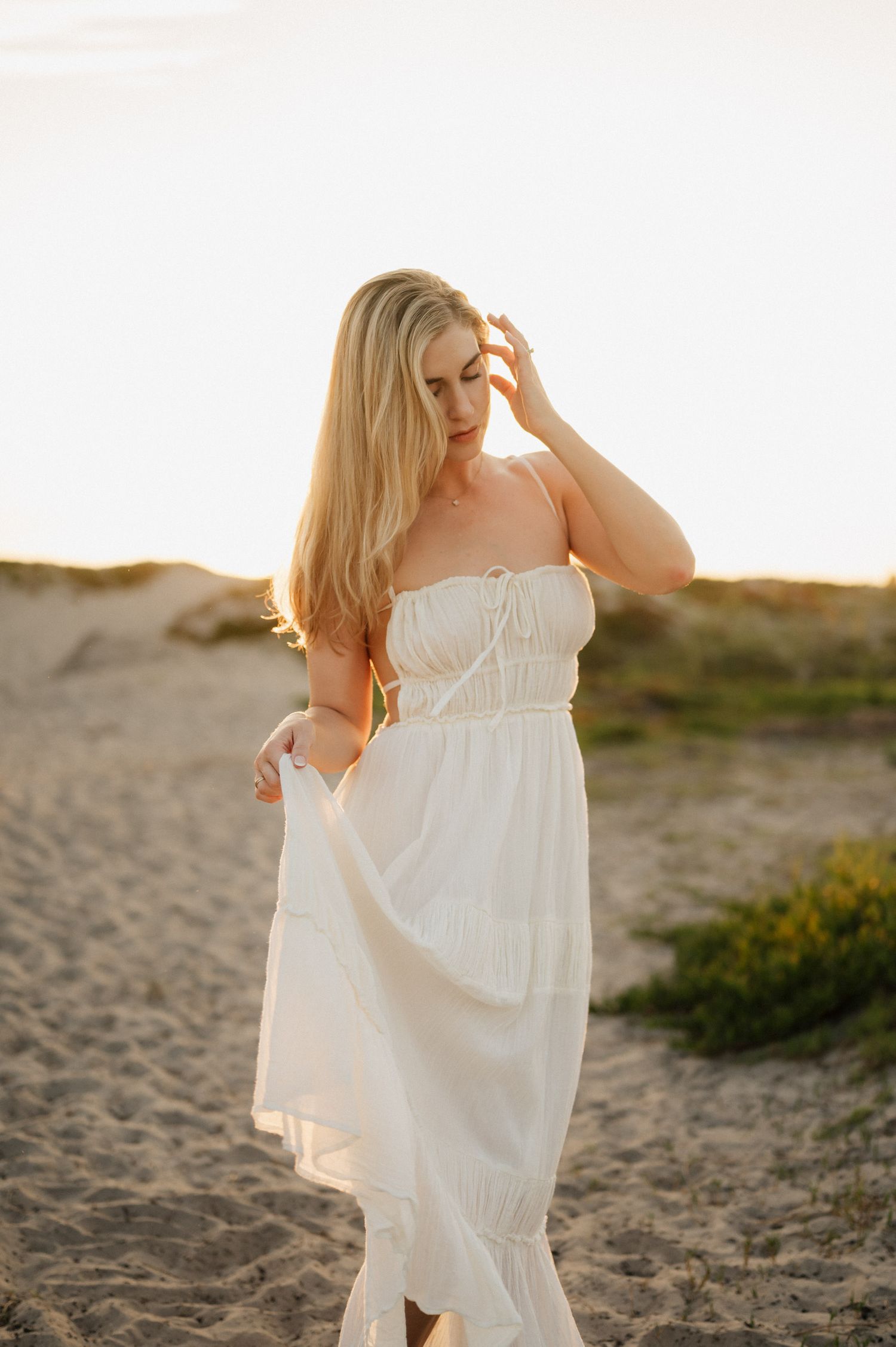 Carpinteria beach portrait photoshoot by Ventura photographer, of woman in free people dress walking in sand