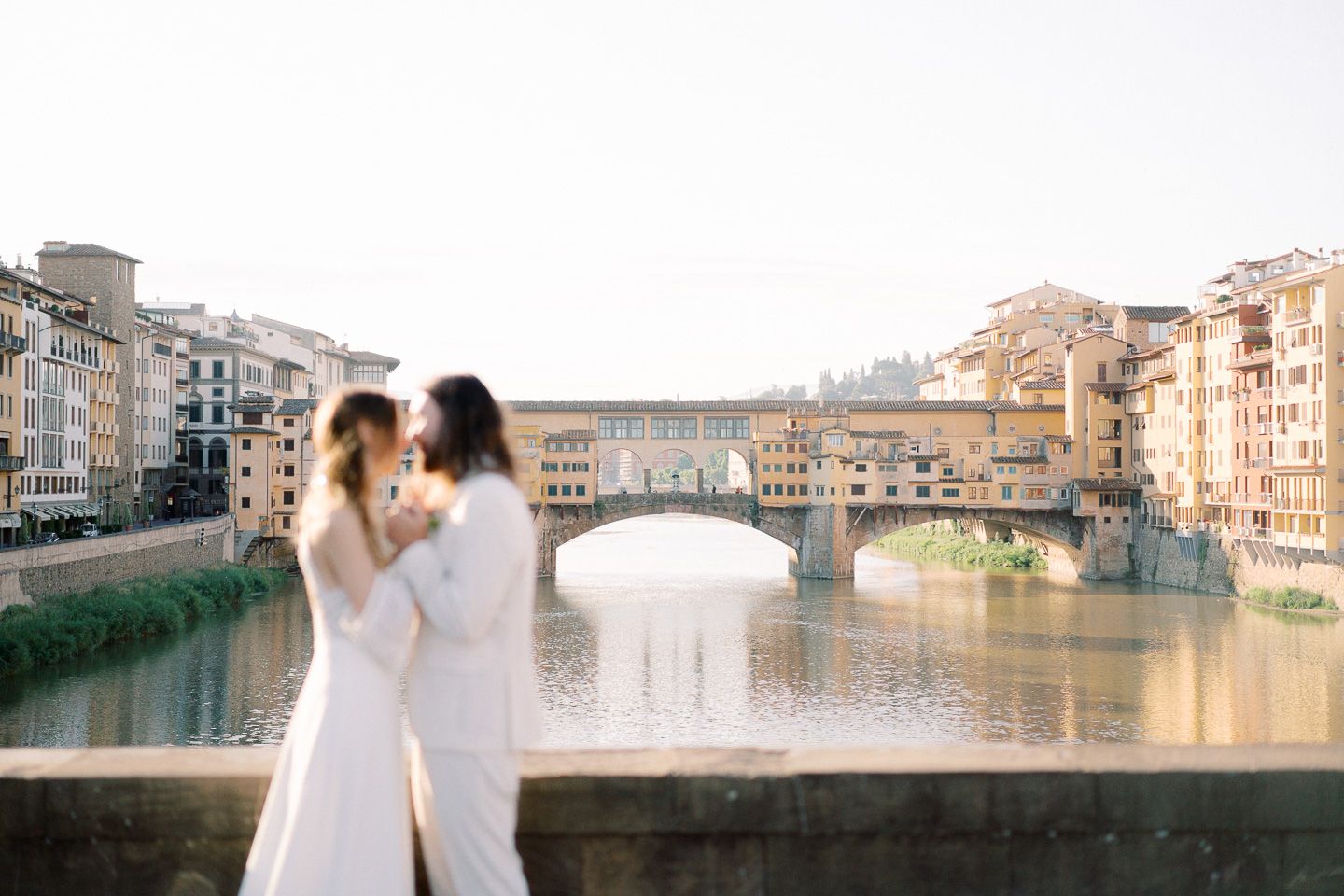 couple hugging and looking at each other at Ponte Vecchio, Florence