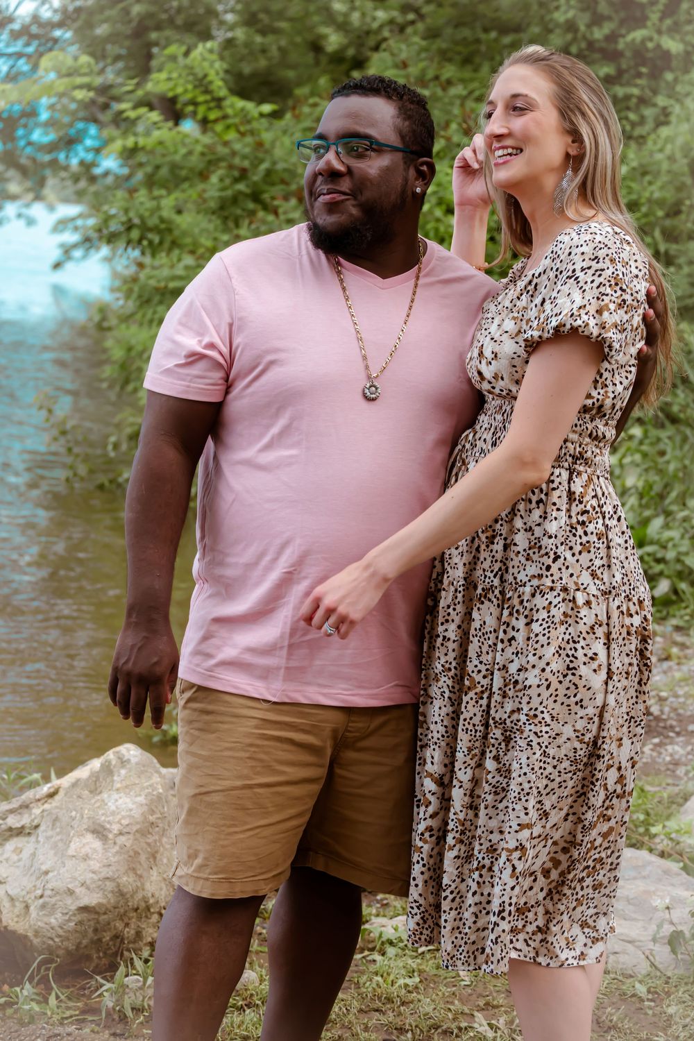 A happy couple shares a lighthearted moment together outdoors.