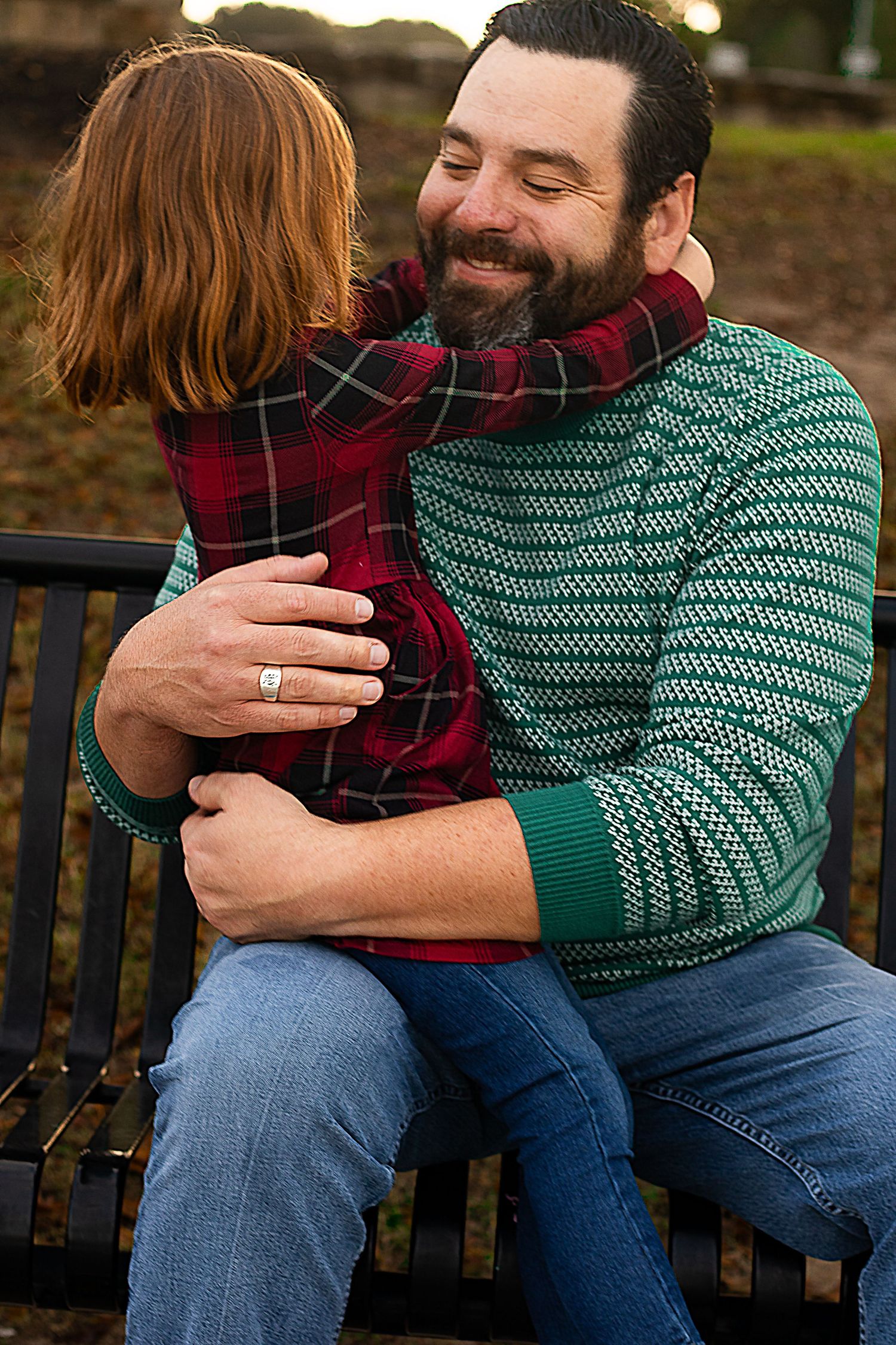 Parent and child sharing tender moments while sitting together on a park bench.