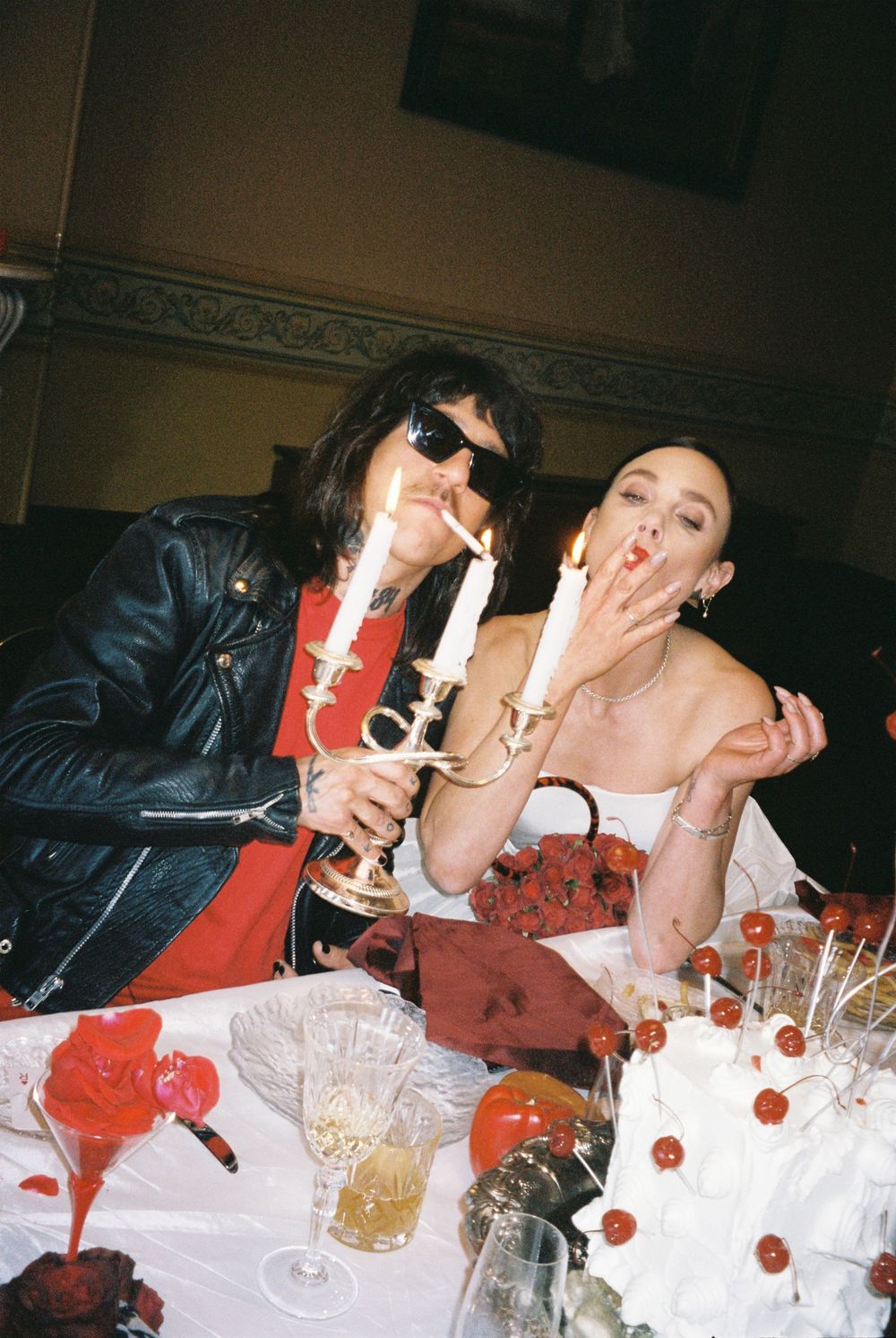 A group of people enjoying drinks and popcorn at a party with candid flash photography capturing the fun atmosphere.