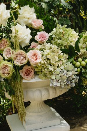 Elegant floral arrangement with white hydrangeas and pink roses in a classic stone garden urn.Best wedding photographer in Adelaide SA