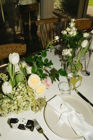 Elegant wedding table setting with white roses and hydrangeas in glass vases. Best wedding photographer in Adelaide SA