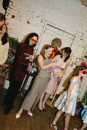 Fun dance party scene with colorful retro outfits and props.