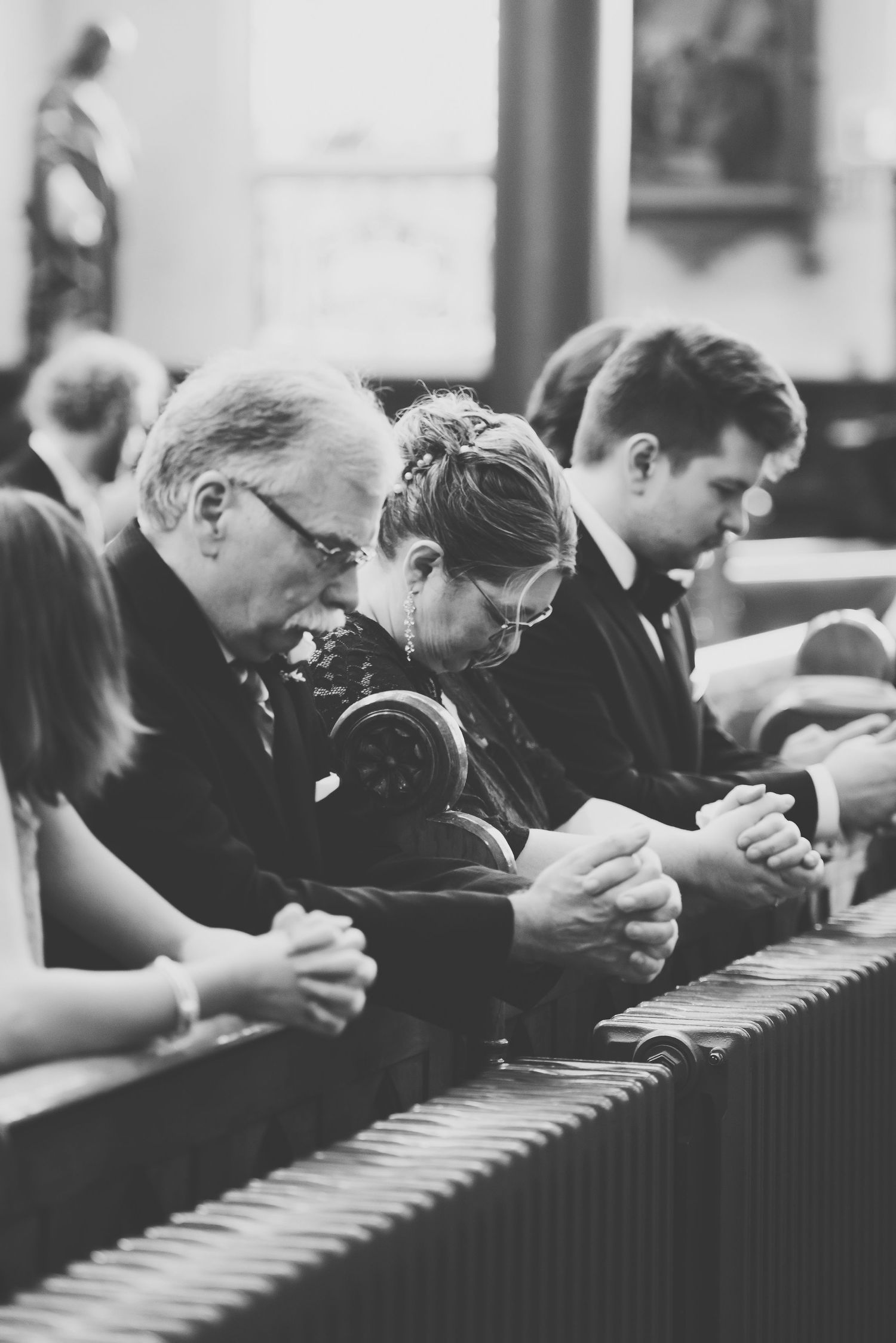 parishioners kneel and pray during mass at st andrew's cathedral in victoria, bc.