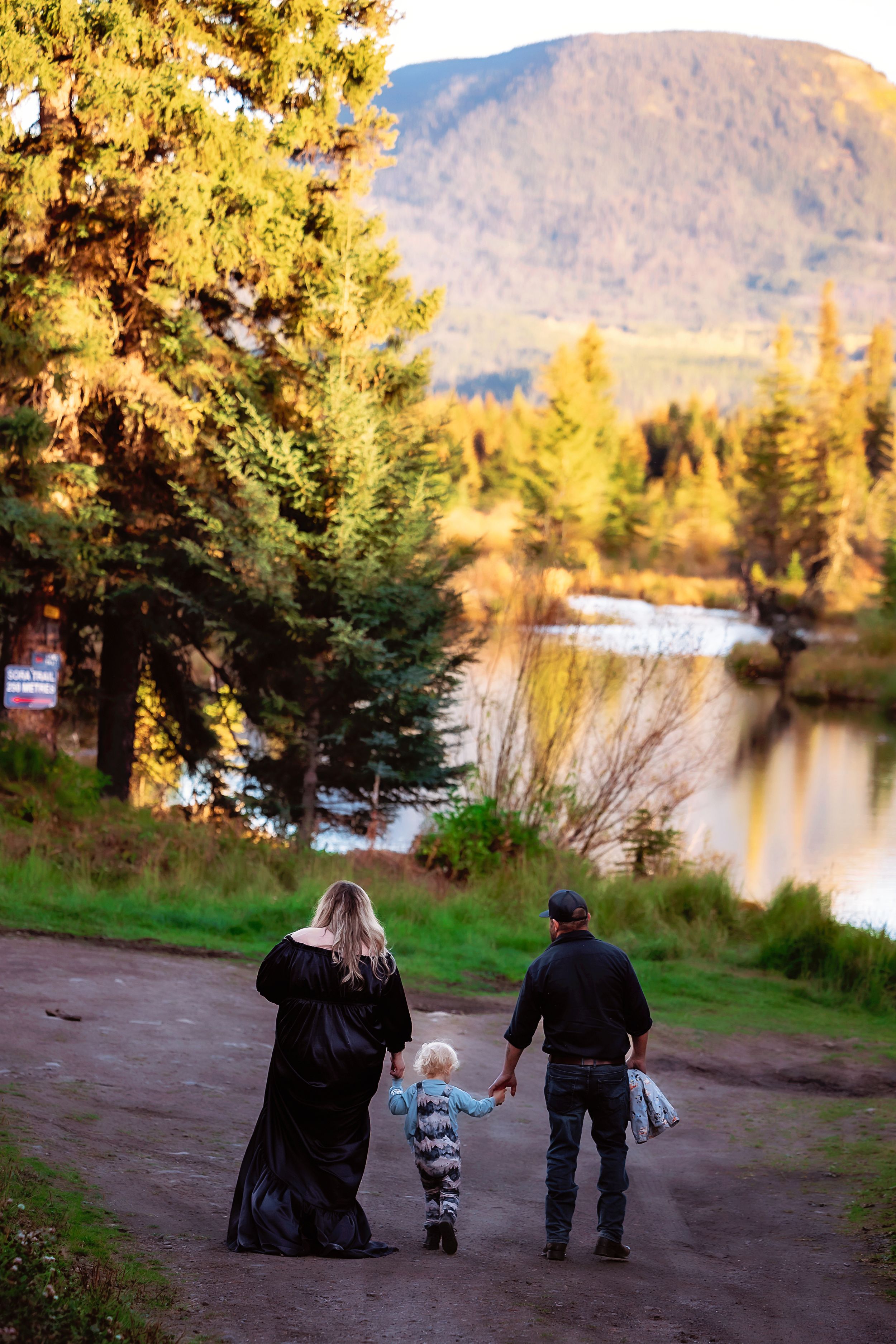 Three connected photos show people sitting by a serene lake surrounded by autumn trees at sunset.