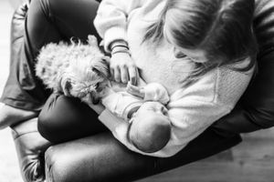 Black and white series of intimate newborn moments on soft blankets.