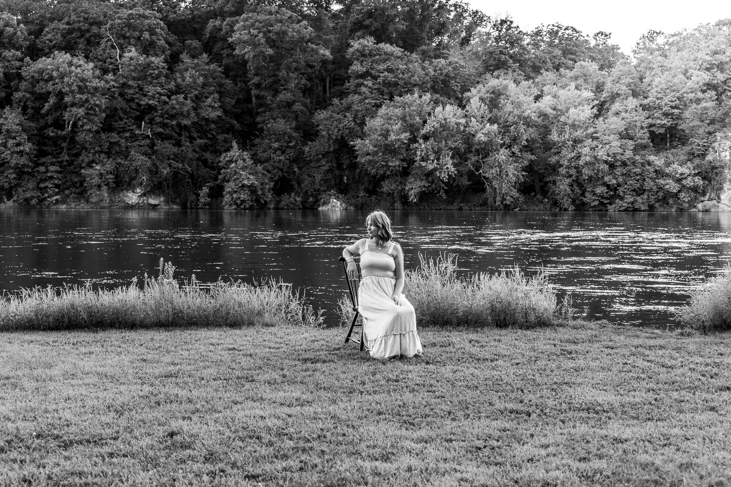 Black and white photo series showing people in a natural outdoor setting by a lake with trees in the background.
