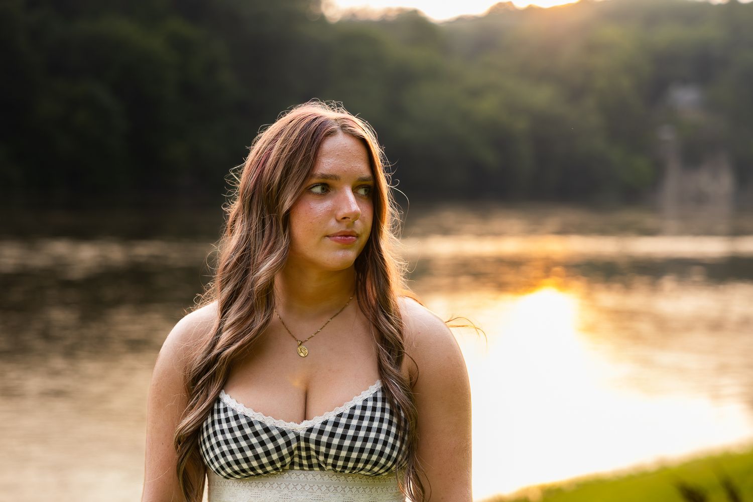 Sunset light illuminates a lake scene with natural scenery at golden hour.