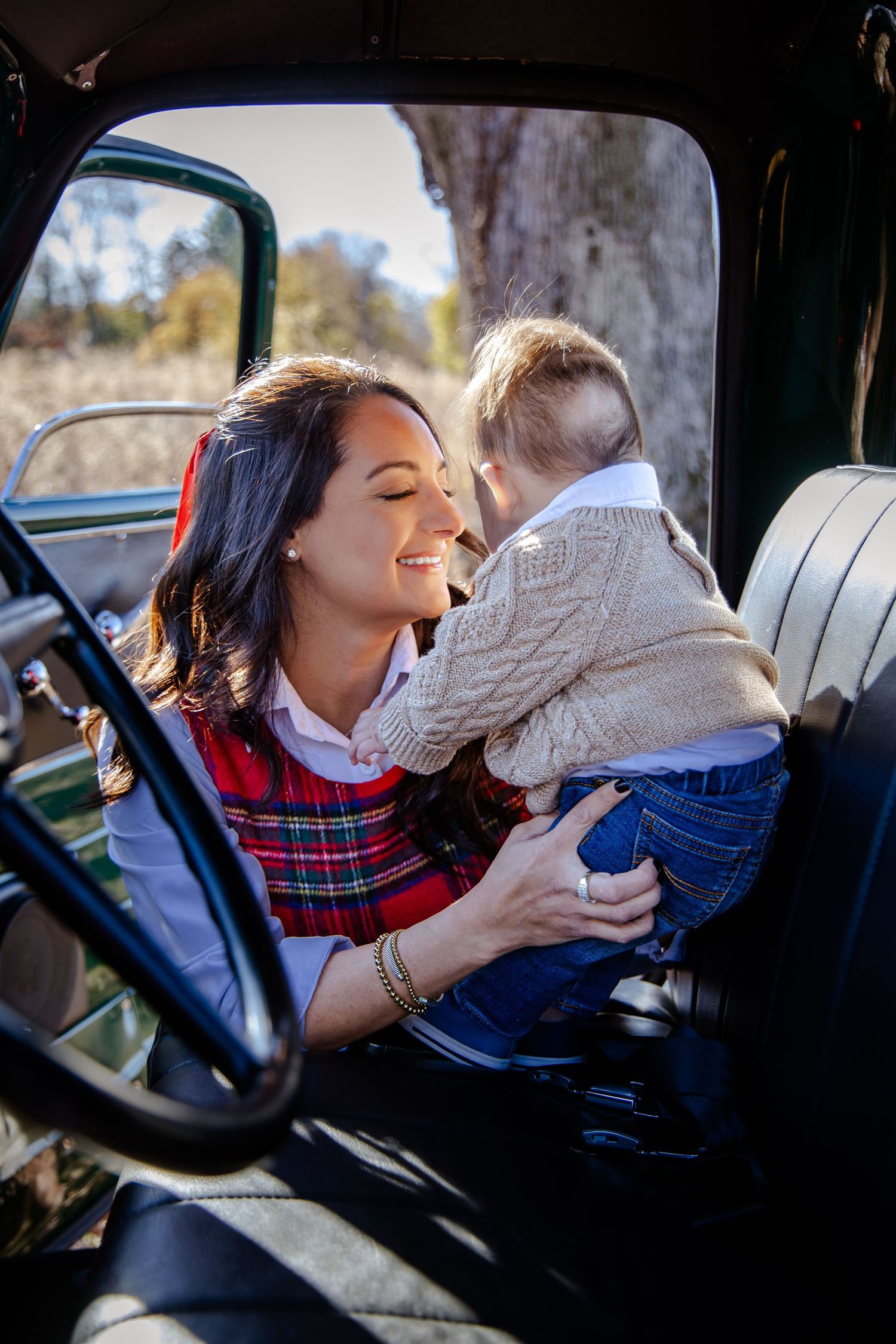 Tender moment shared in the backseat of a vintage car.