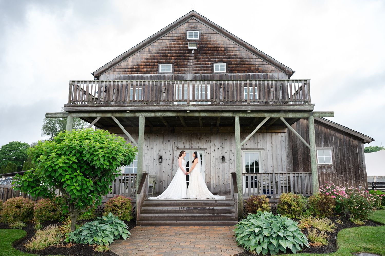Wedding toast moment at elegant reception with white floral centerpieces.