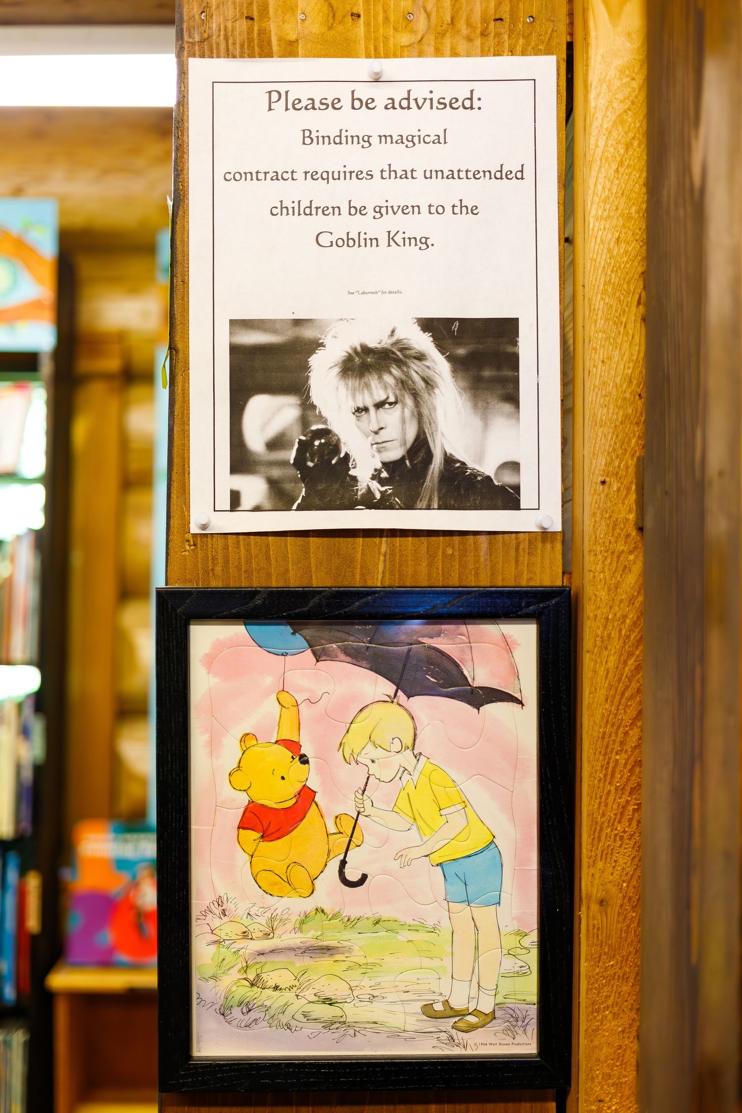 Classic Winnie the Pooh illustration displayed below a framed movie reference sign.