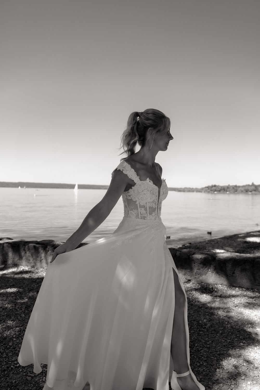 Dramatic black and white shots of bride's dress flowing in coastal breeze.
