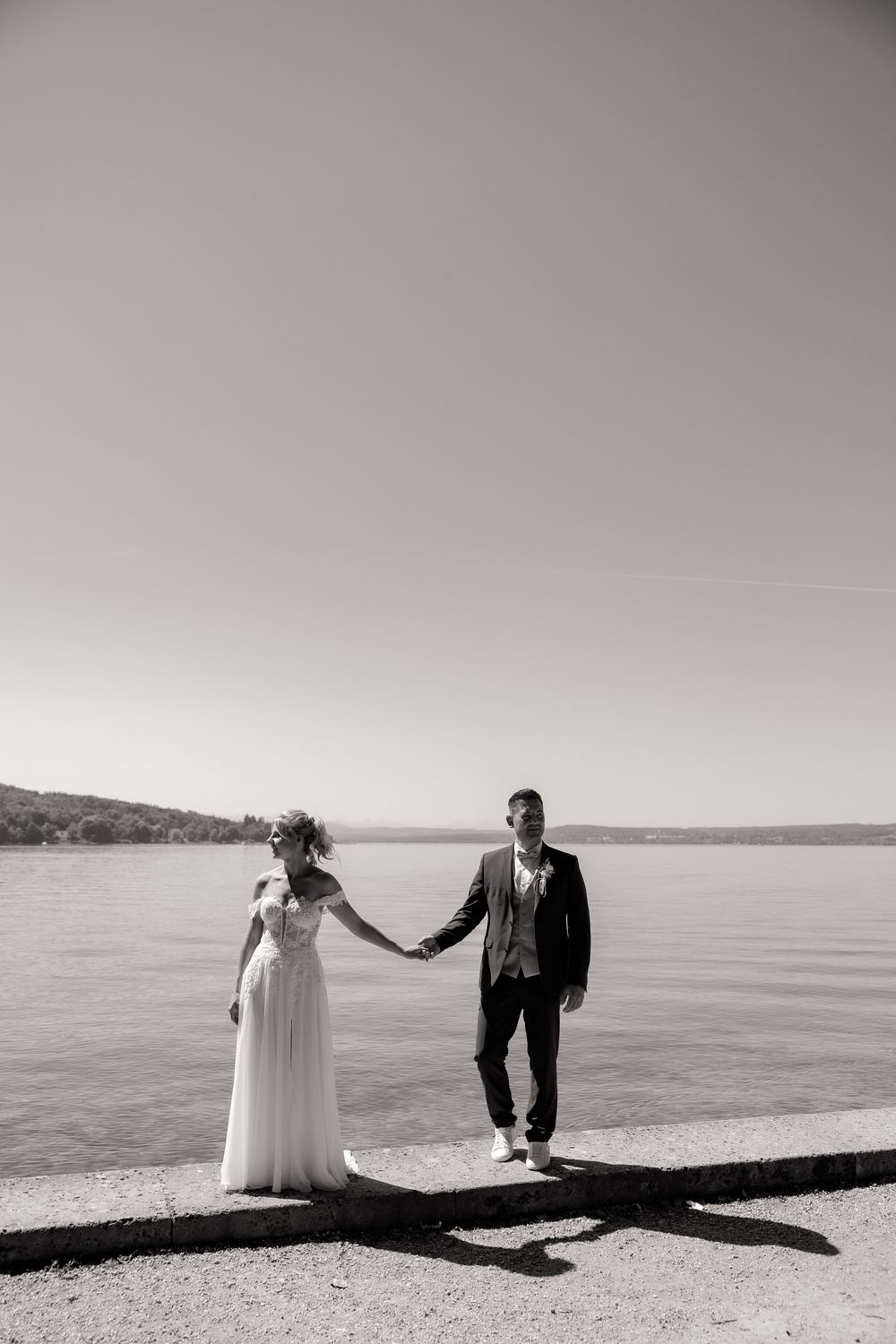 A seaside wedding photoshoot with dramatic shadows on a bright beach.