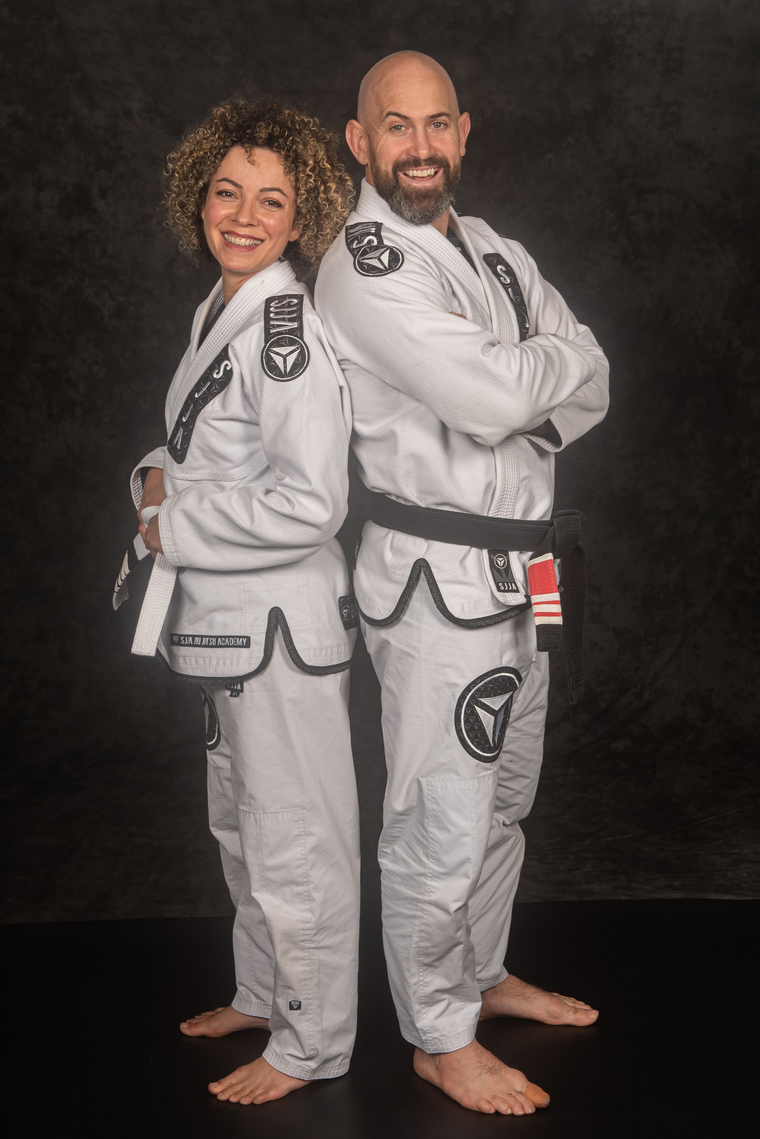 Martial artists in white uniforms showing different poses against dark studio background.