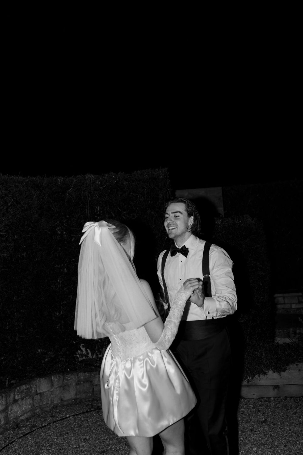 Black and white photos of newlyweds dancing together in formal wedding attire.