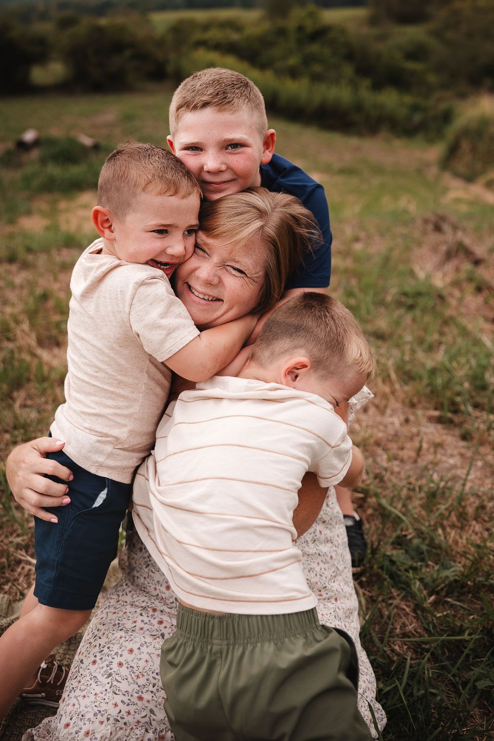 A heartwarming sequence of candid outdoor family moments showing hugs and embraces in a natural setting.