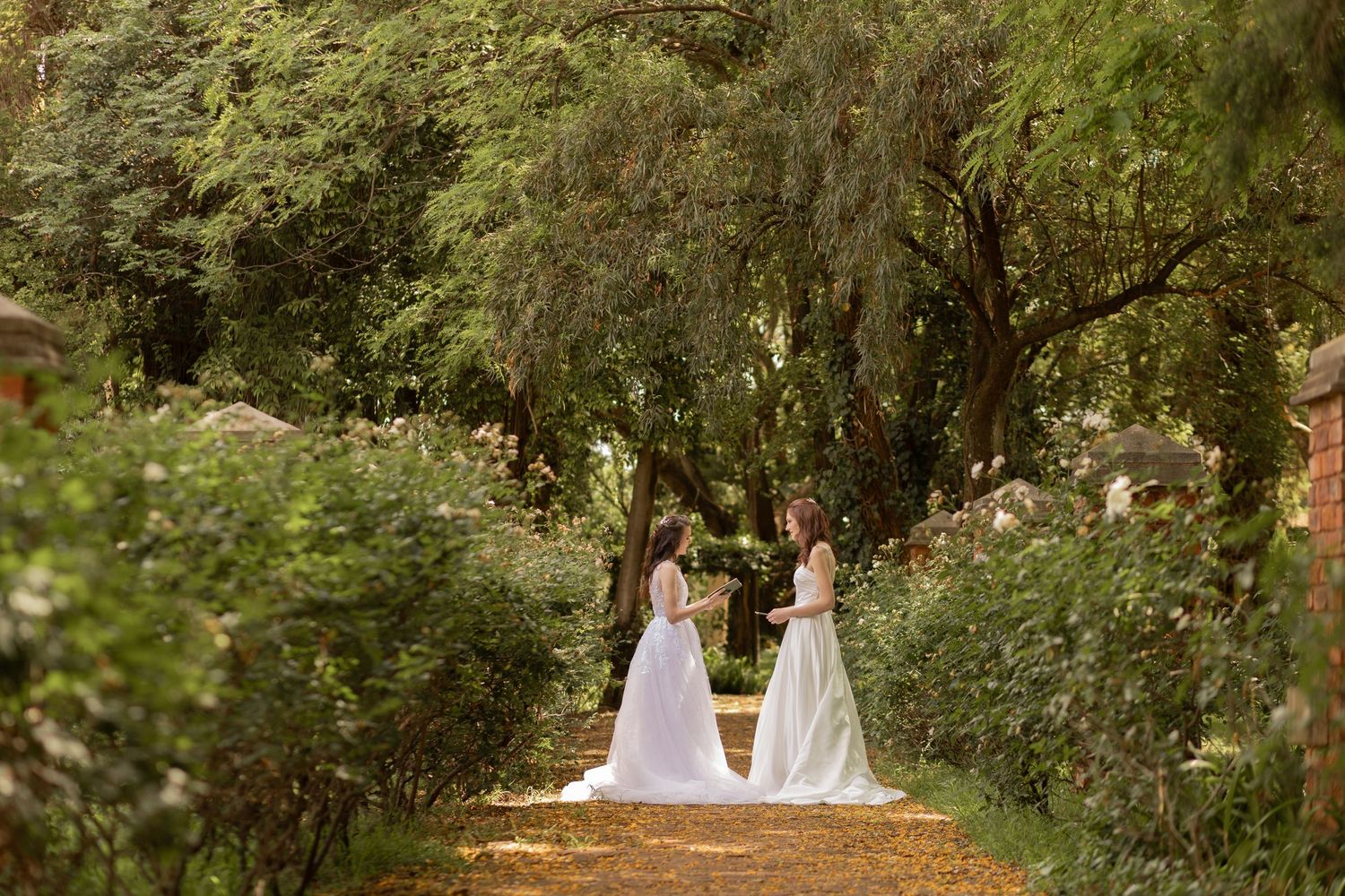 Bride and bridesmaid walking together in garden during wedding preparation in Gauteng with natural, candid style