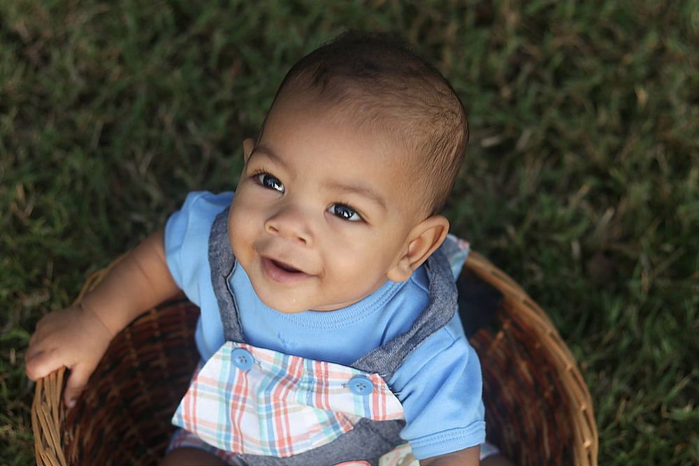 smiling baby in a basket portrait in downtown Kennesaw