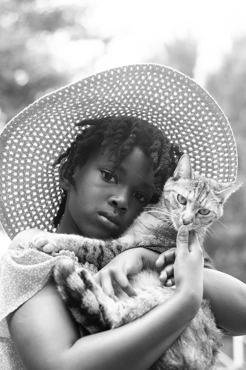 little girl with a hat and her cat black and white portrait in Acworth Georiga