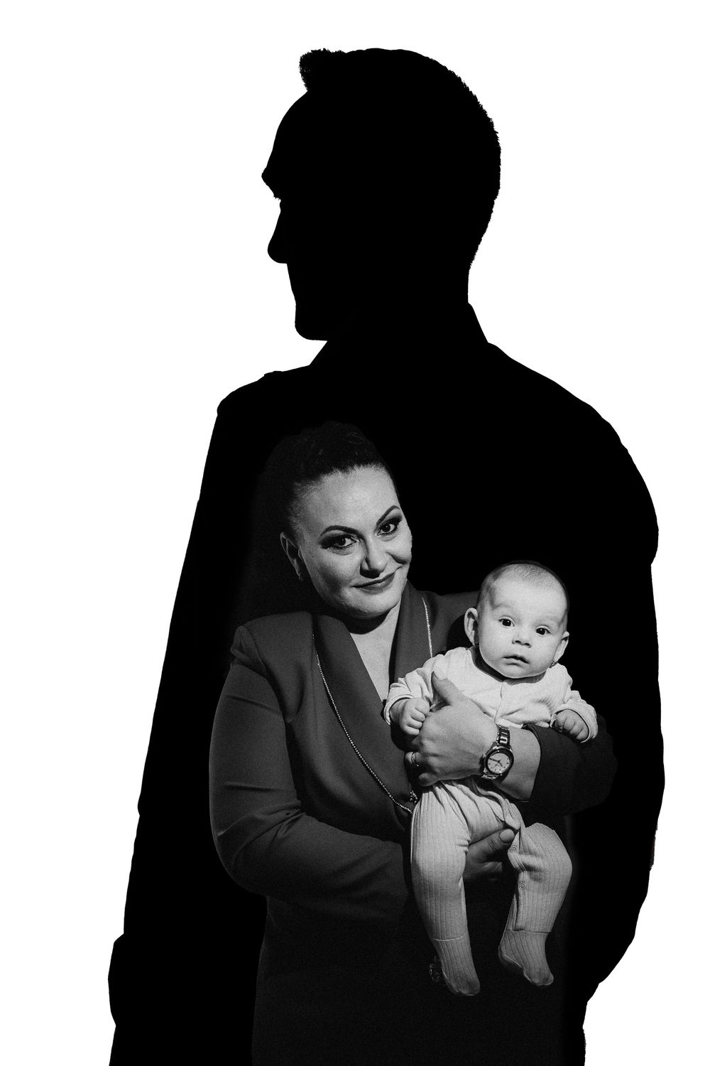 A series of black and white photos showing a parent holding and interacting with a baby in different poses.