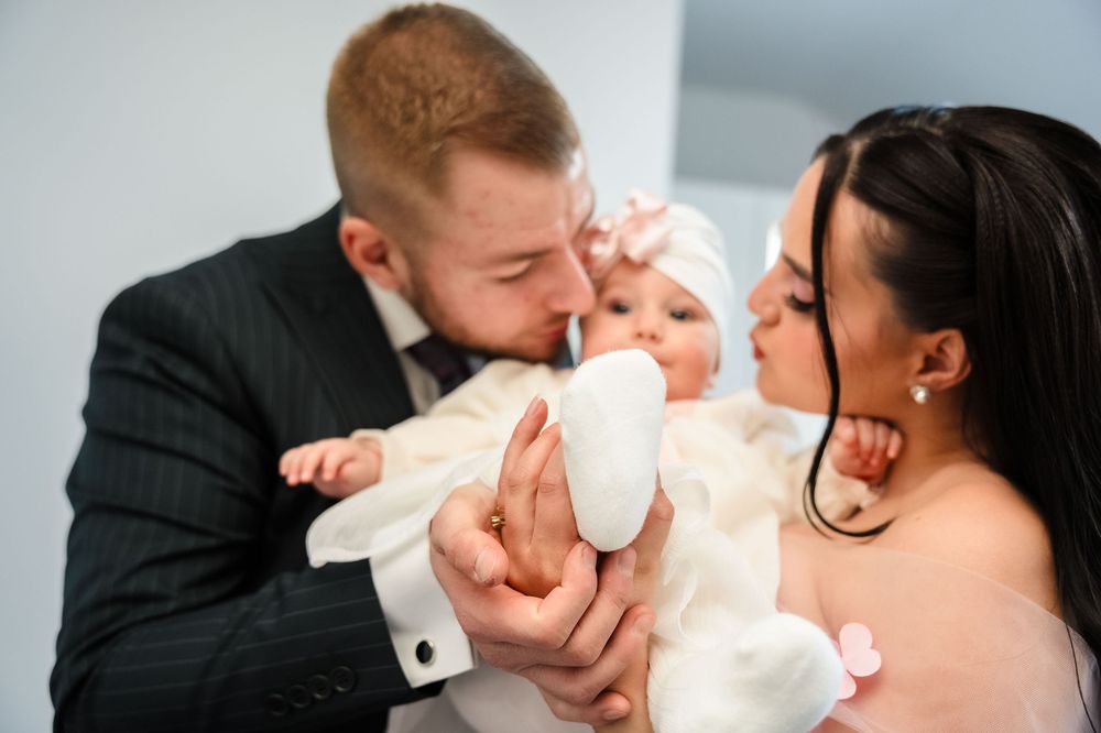 A series of five tender moments between a couple with their newborn baby, showing gentle kisses and cuddles.