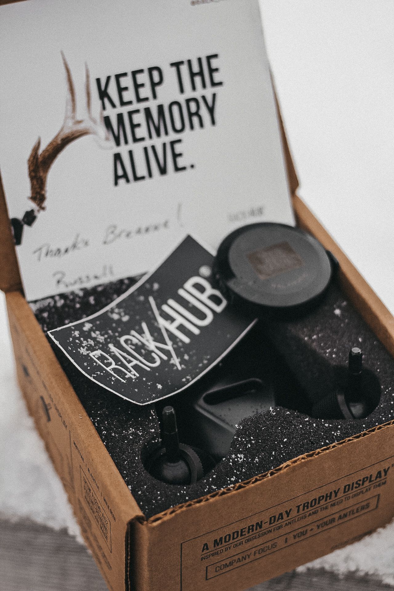Open box displaying 'Keep the Memory Alive' merchandise and packaging.