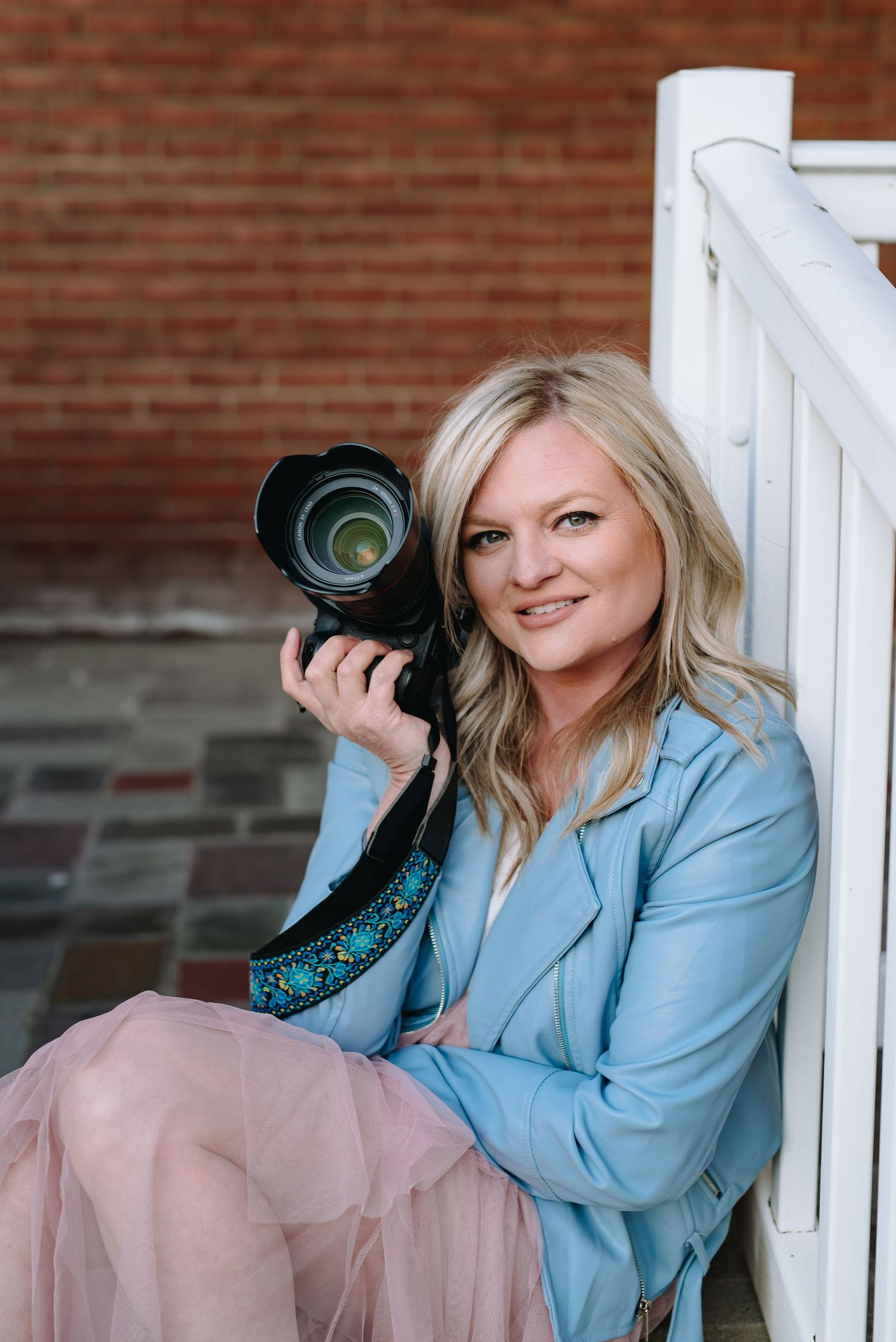 Buffalo and Rochester Wedding and Engagement Photographer Jess Trankle Images poses with her camera.