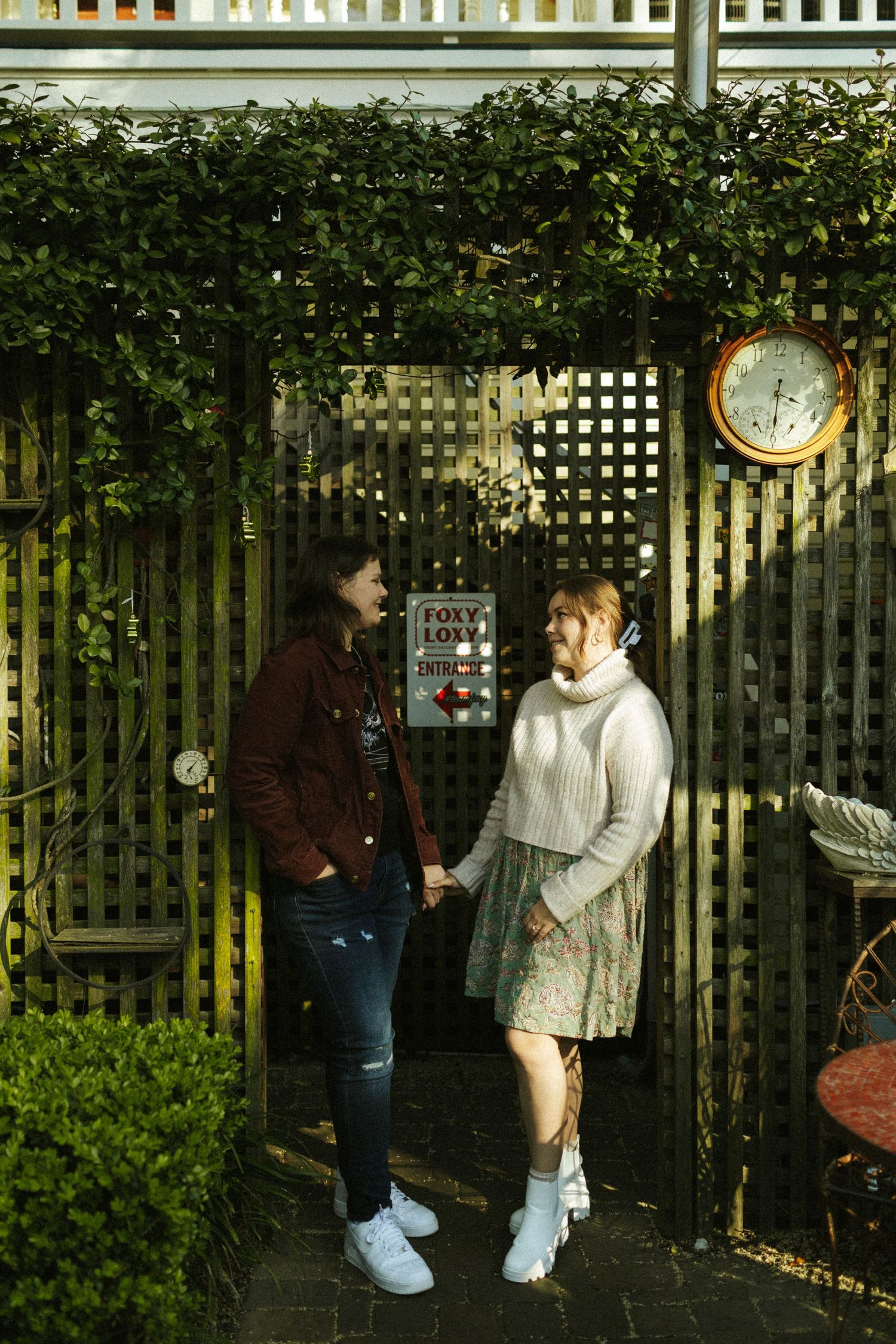 Two women lean in a doorway at Foxy Loxy Coffee Shop in Savannah