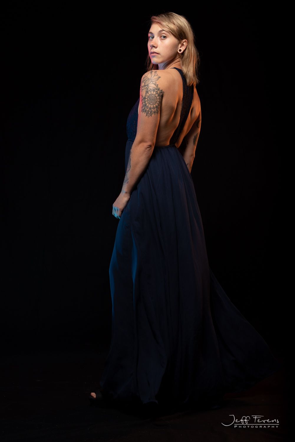 Woman in studio looking over her shoulder.