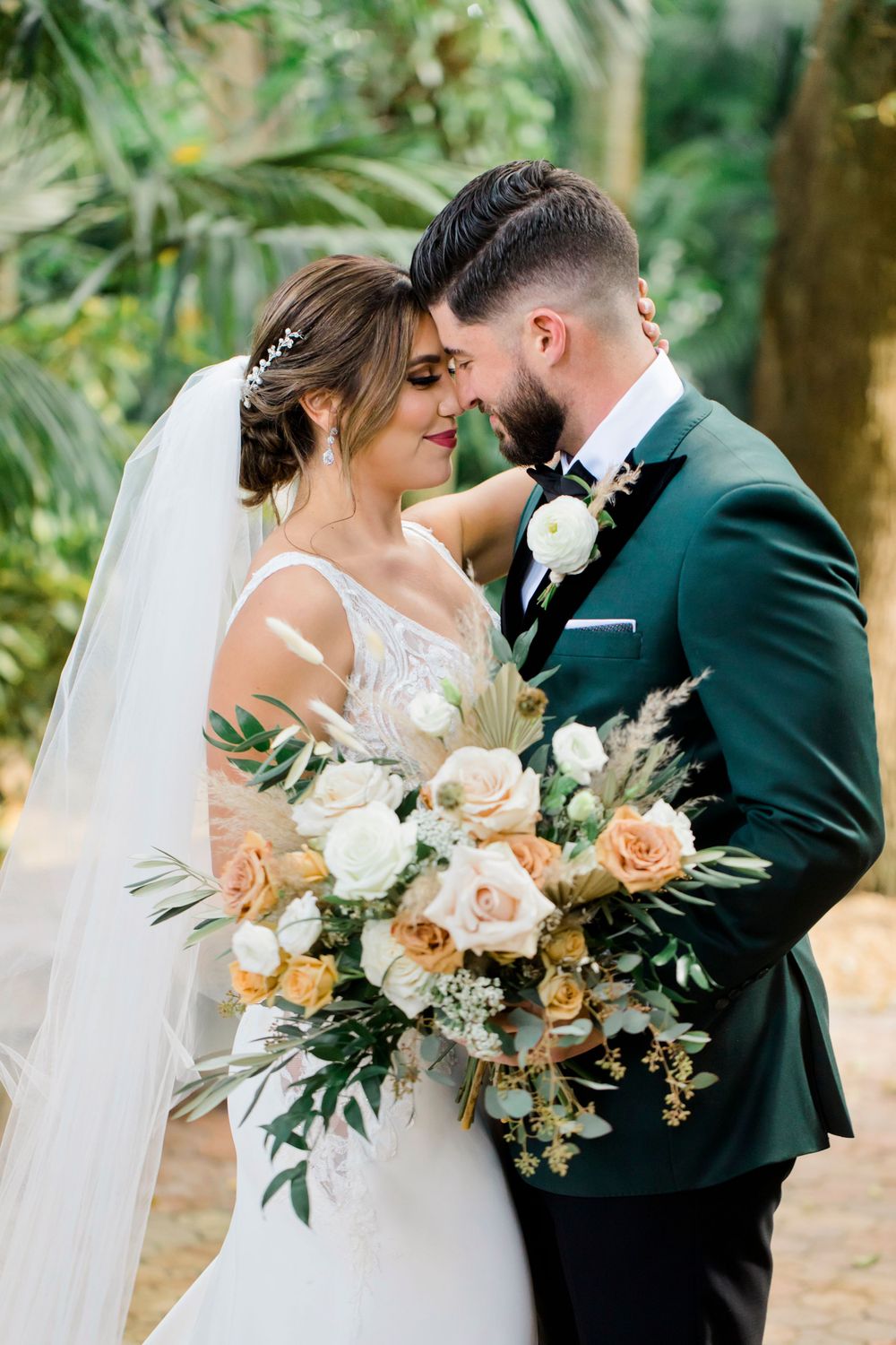 Romantic garden wedding portrait with peach and white floral bouquet.