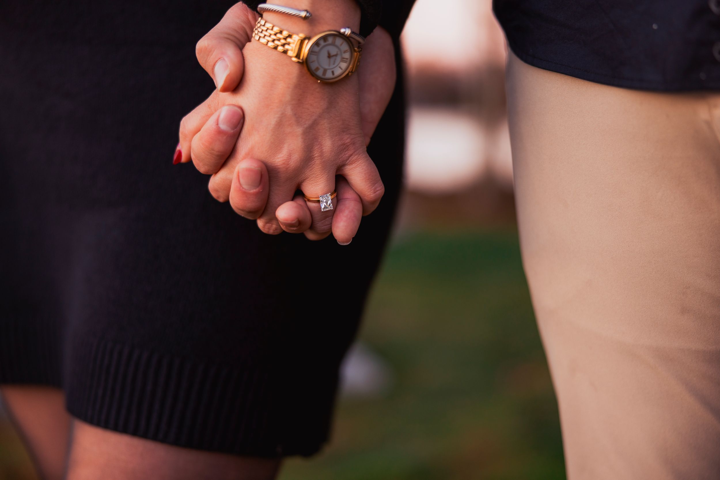 Close-up of intertwined hands showing connection and intimacy.