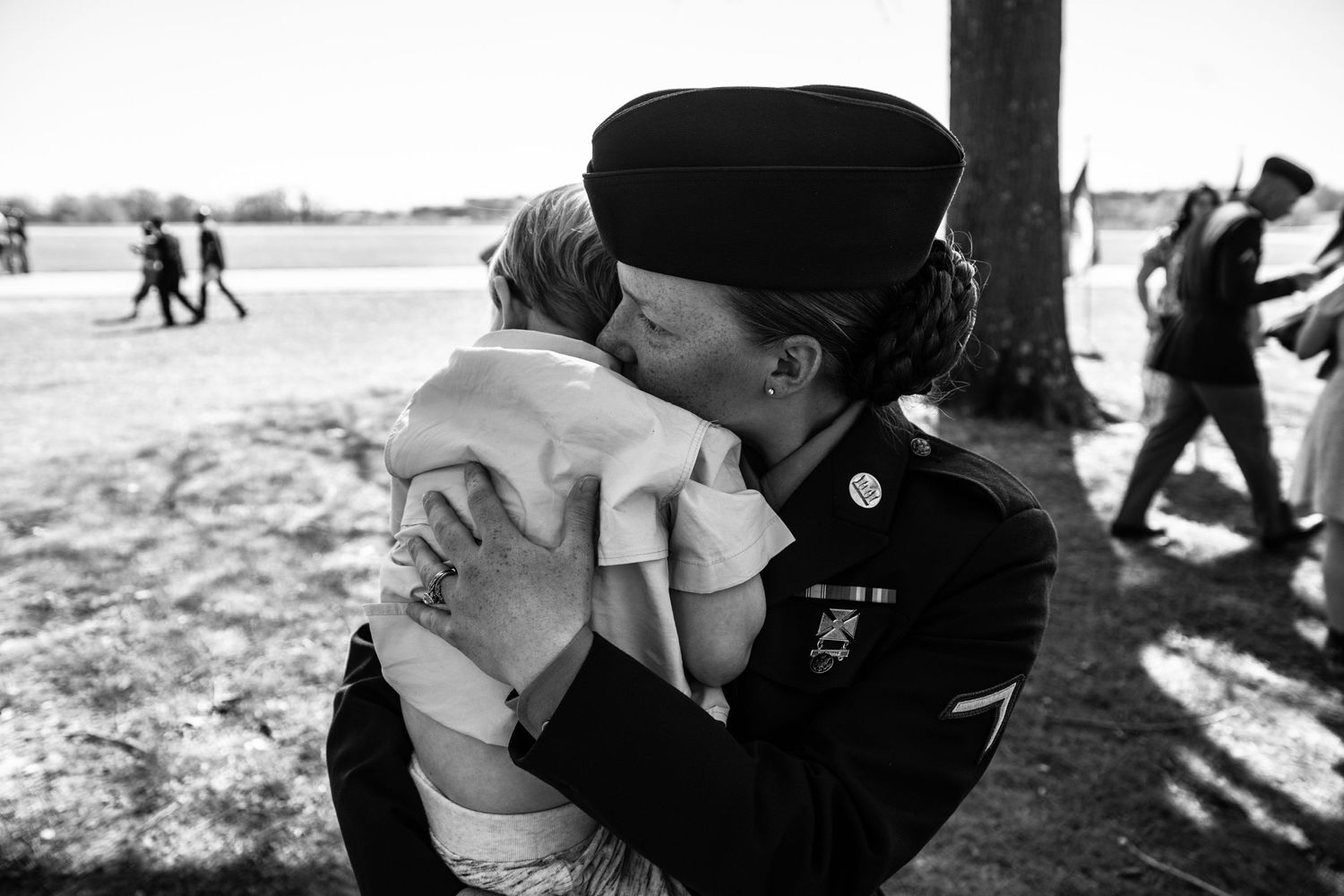 woman at military graduation holding child