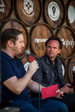 Interview session against backdrop of wooden barrels at craft brewery or distillery.