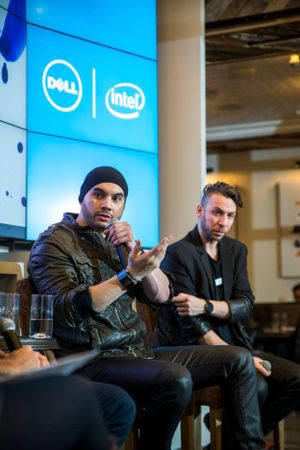 Panel discussion under Dell and Intel signage during tech conference event.