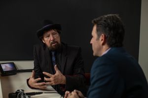 Two people having an intense discussion during a business meeting in a dark room.
