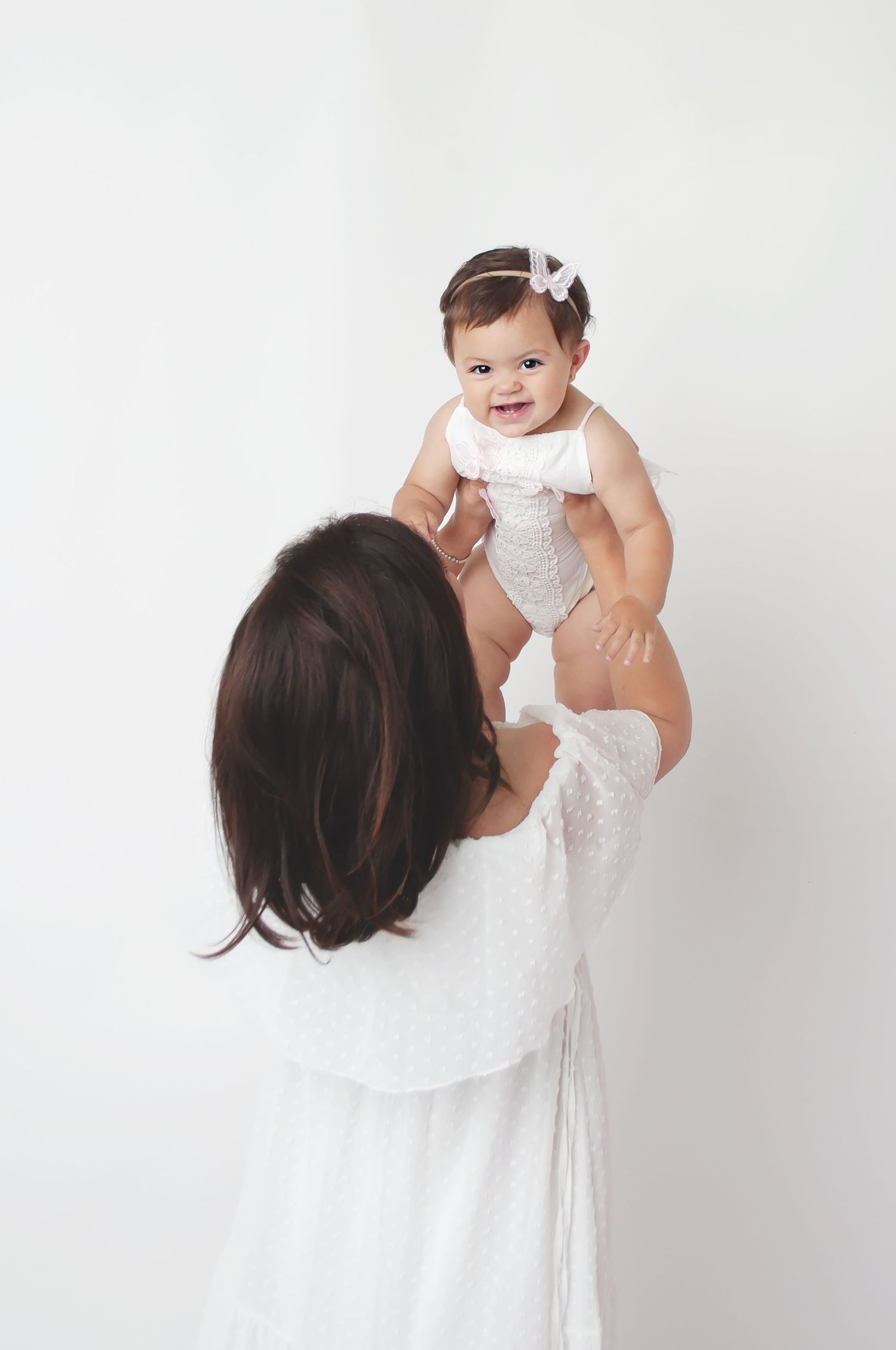 mommy and me 1 year milestone in white with white backdrop