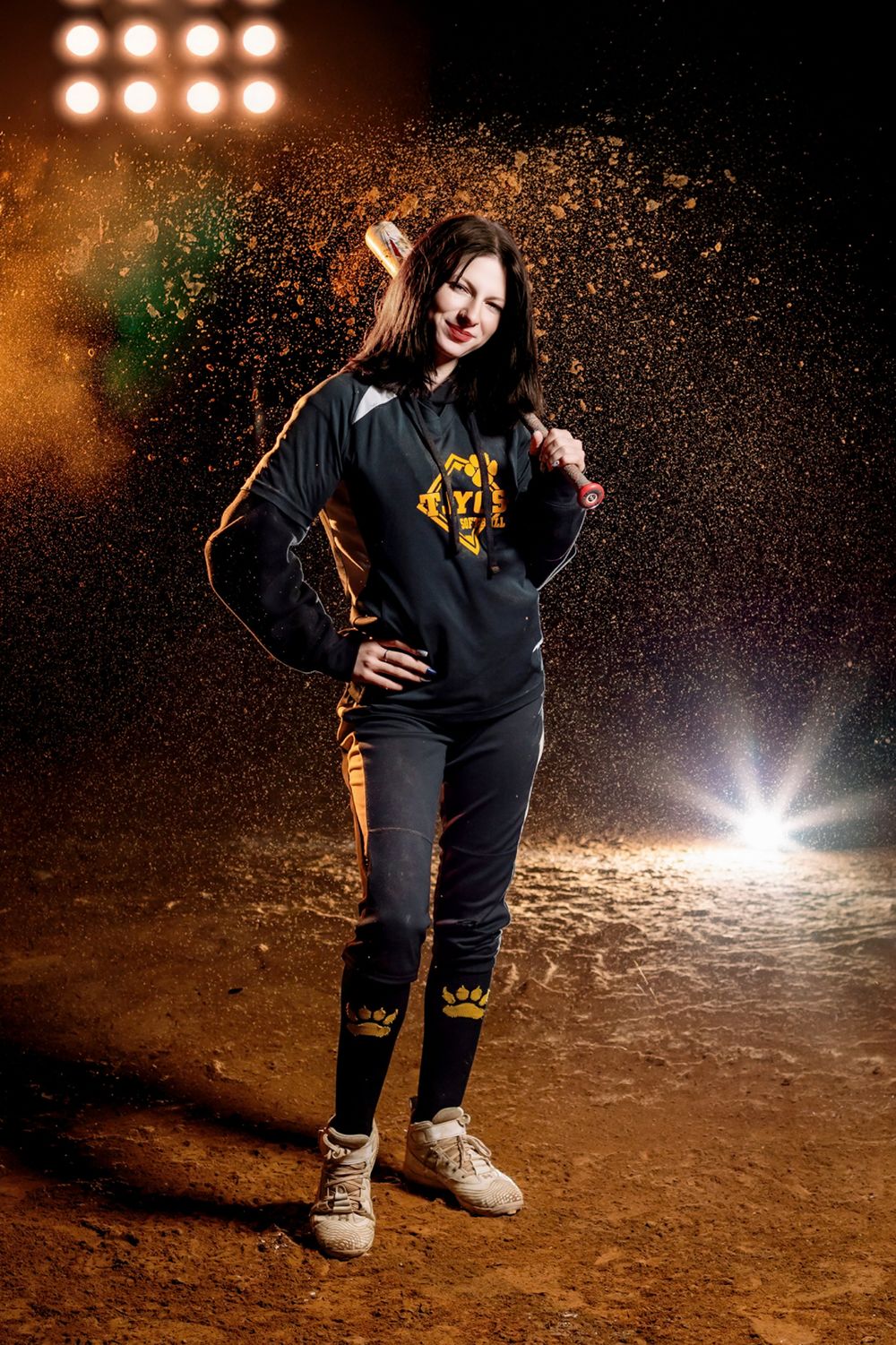Dynamic action shot with colorful powder splash effect against dark background and bright stage lighting.