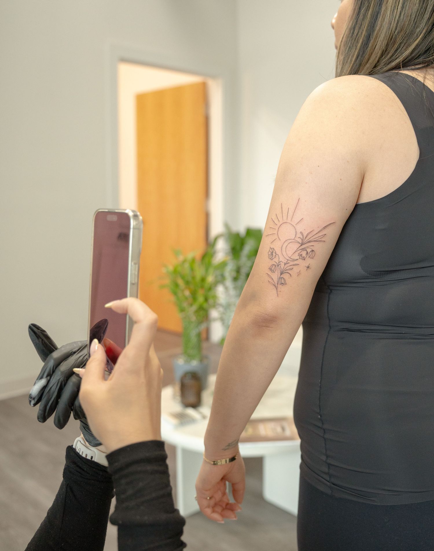 Floral tattoo design on arm being prepared for application.