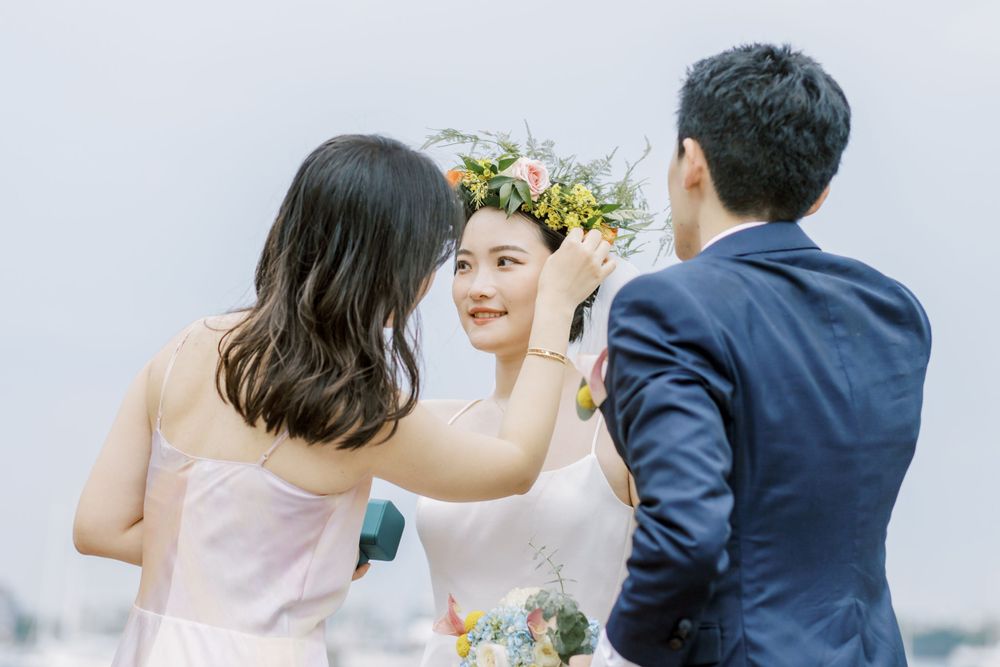 Candid wedding moment captured against a bright sky with soft lighting.