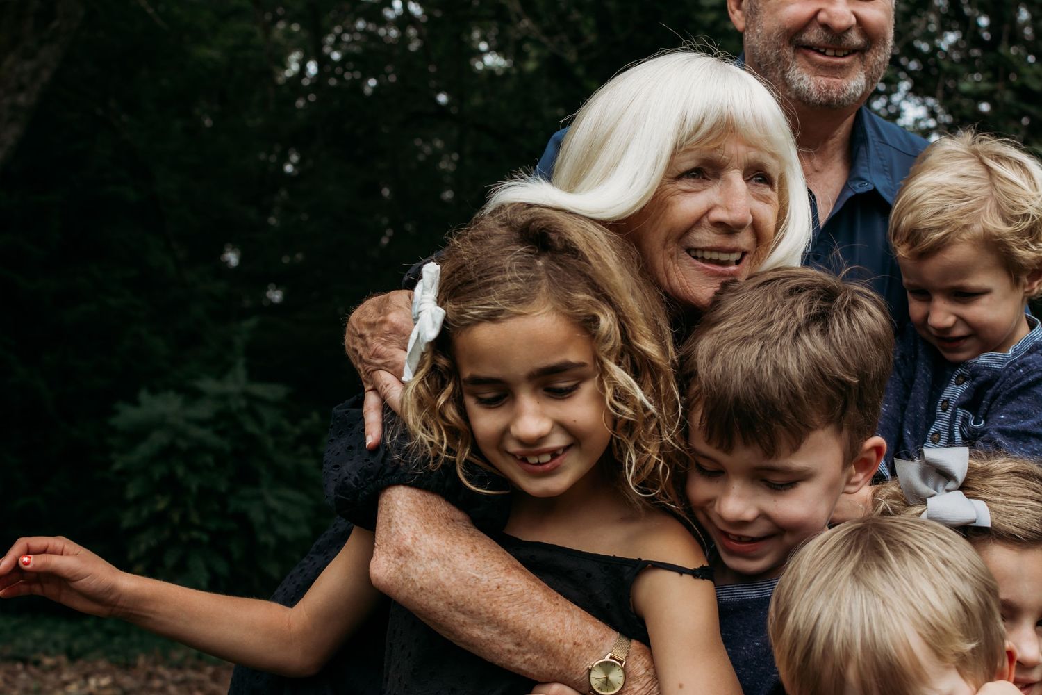 grandparents hugging their grandchildren