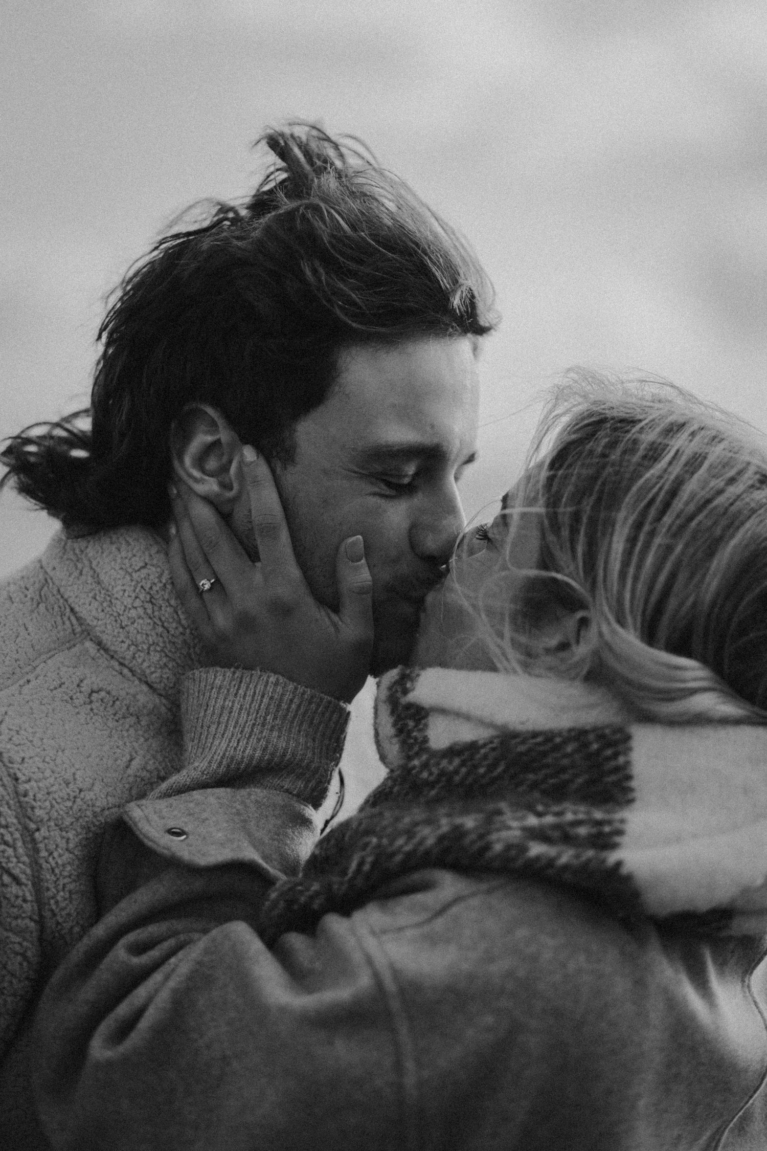 An intimate black and white close-up of a tender moment shared between two people.