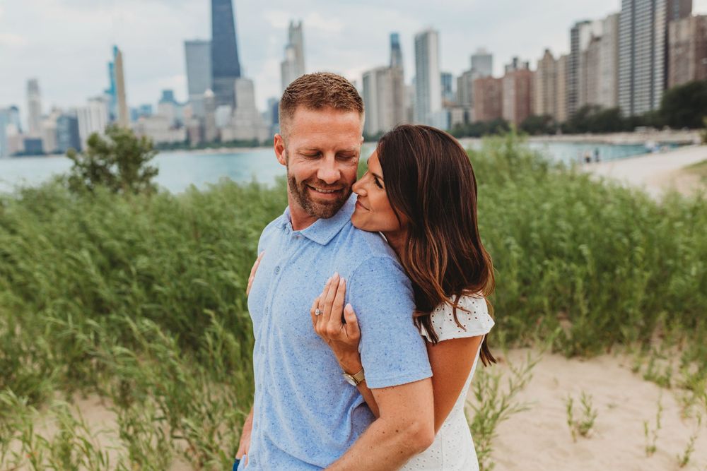 Romantic beach photoshoot with Chicago's distinctive skyline in background.