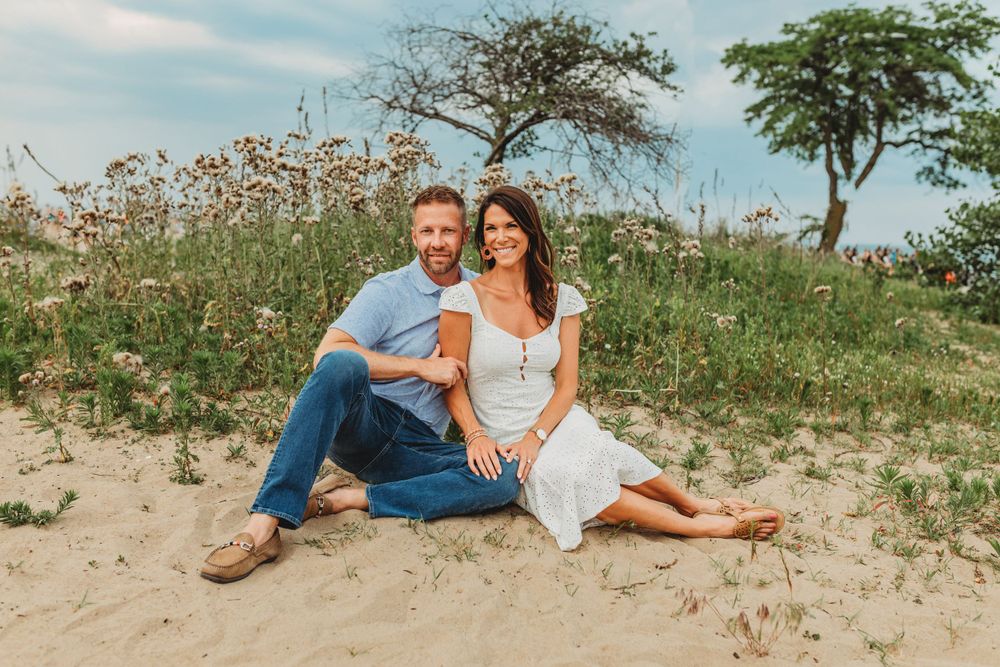 Natural beach landscape provides setting for family portraits with urban backdrop.