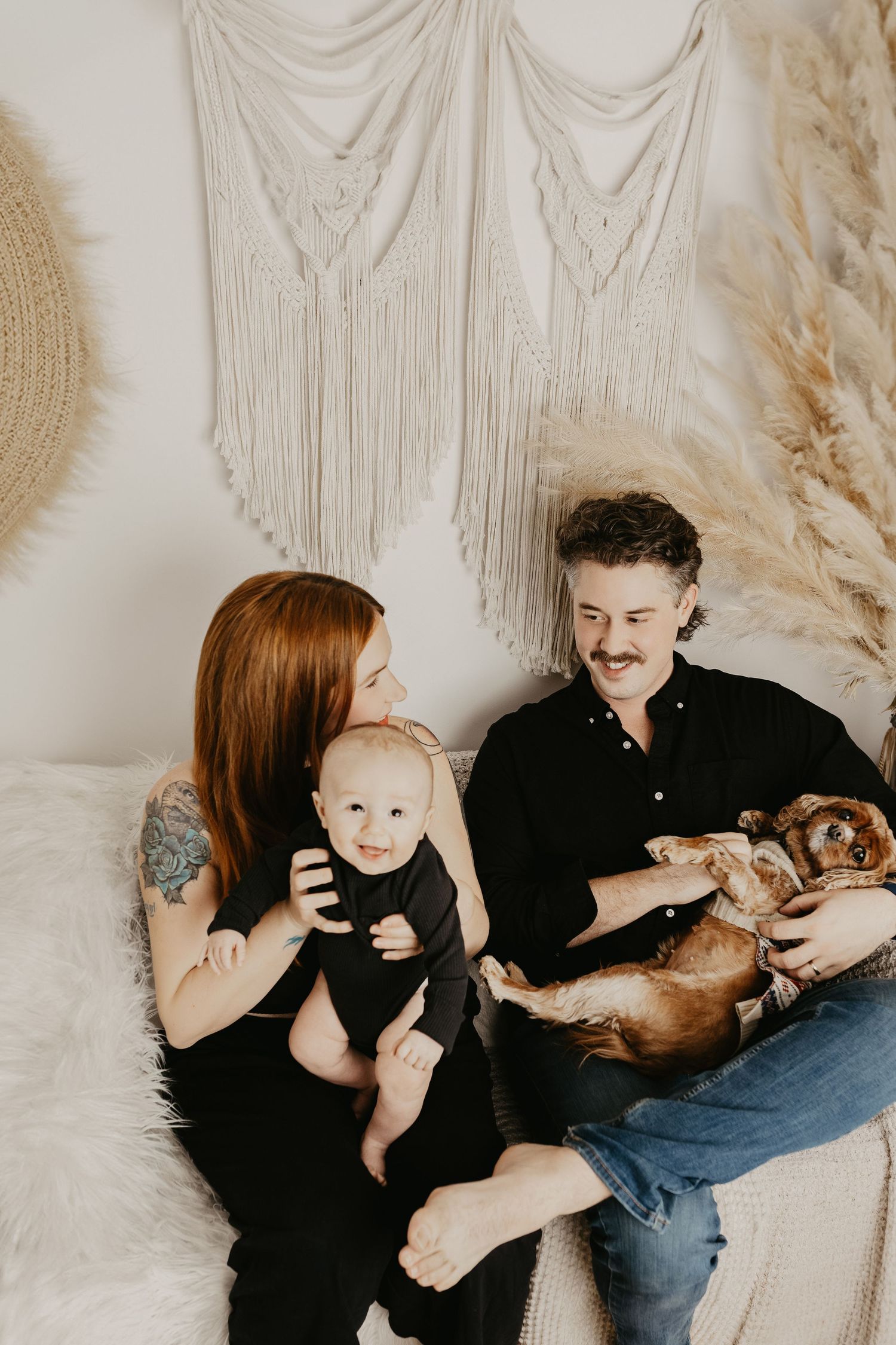 Modern family photo session with minimalist decor and natural lighting.