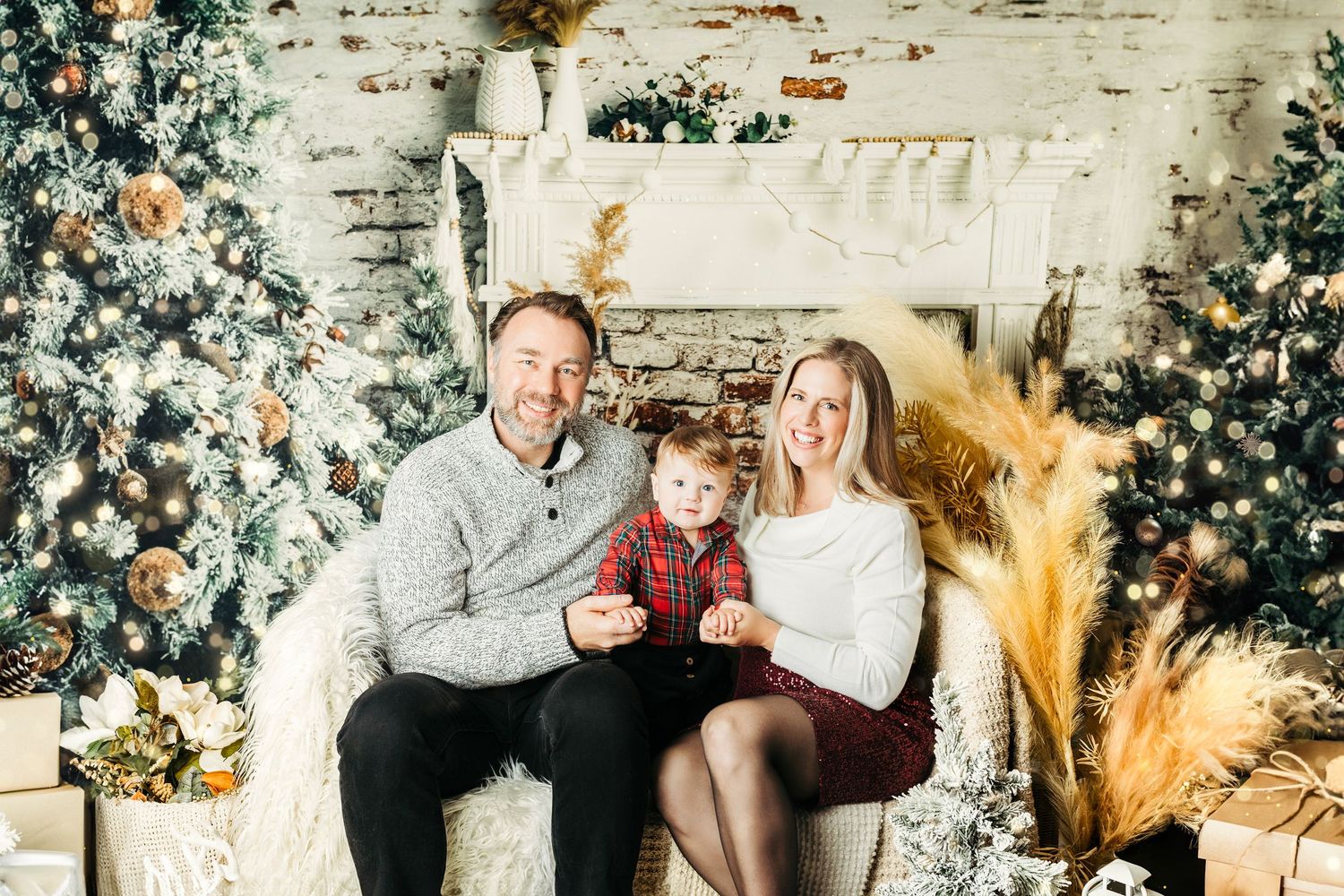 Christmas themed family photo session with decorated tree and festive holiday backdrop.